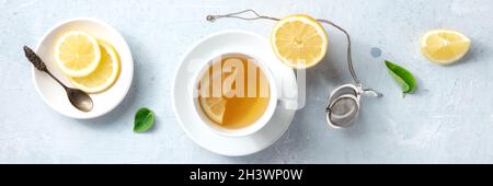 Lemon tea in a cup, overhead flat panorama. Organic lemons, shot from above Stock Photo