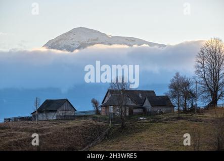 Picturesque morning above late autumn mountain countryside.  Ukraine, Carpathian Mountains, Petros top in far. Peaceful travelin Stock Photo