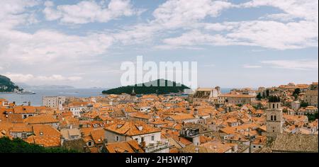 Panoramic view of the whole old city of Dubrovnik. View from the wall to the tiled roofs. Stock Photo