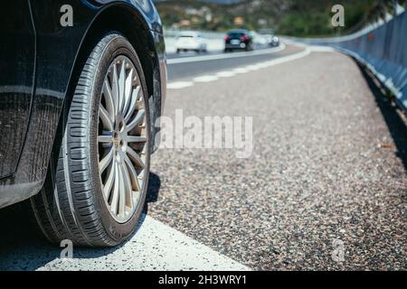 Tyre of a car on the emergency lane, breakdown Stock Photo