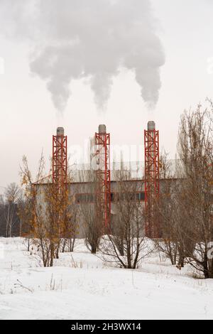 The waste gas chimneys of a facility heated with natural gas are smoking. Stock Photo