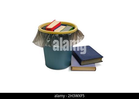 Trash can and the books thrown into it, on a white background, are isolated Stock Photo