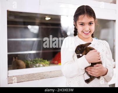 Portrait of cute girl holding small rabbit Stock Photo