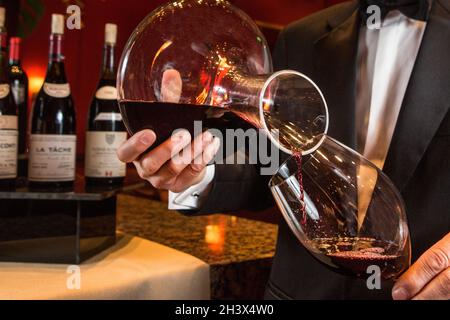 The hands of a professional bartender pour red syrup into a measuring glass  of jigger, next to a metal tool for preparing and stirring alcoholic cockt  Stock Photo - Alamy