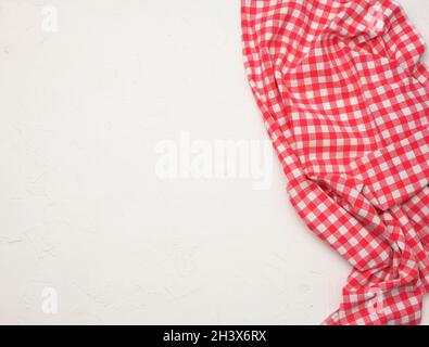 Folded cotton red white checkered napkin on a white background Stock Photo