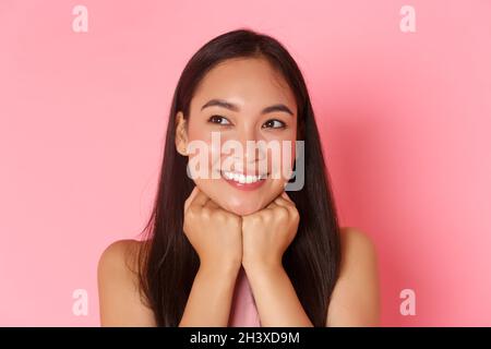 Beauty, fashion and lifestyle concept. Close-up of dreamy and romantic, attractive asian girl daydreaming, leaning face and look Stock Photo