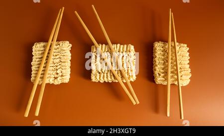 Raw dried instant noodles with chopsticks with copy space. Asian food. minimalism. pasta, for the preparation of which it is eno Stock Photo