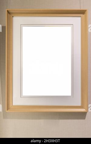 Blank modern wooden picture frame on wall Stock Photo