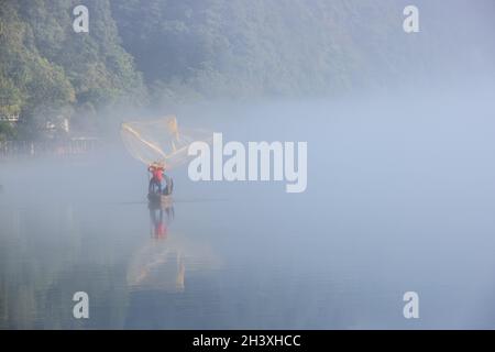 Casting fishing net closeup on mist river Stock Photo