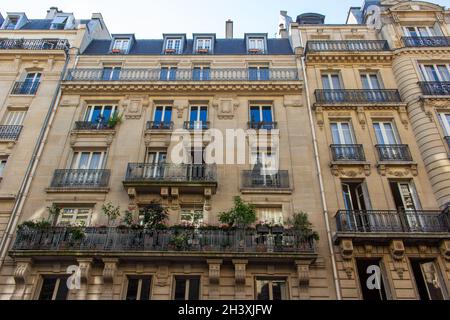 Close up exterior texture view of traditional French architecture, with stone walls and beautiful ornate balconets Stock Photo