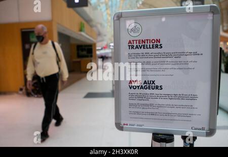 Mississauga, Canada. 30th Oct, 2021. A mandatory vaccination sign for travelers is seen at Toronto Pearson International Airport in Mississauga, Ontario, Canada, on Oct. 30, 2021. Beginning Saturday, travelers who are 12 years of age or older need to provide proof that they have been fully vaccinated against COVID-19 while taking their trips within Canada or overseas. Credit: Zou Zheng/Xinhua/Alamy Live News Stock Photo