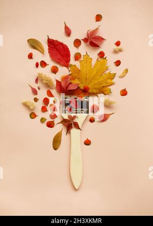 Paintbrush with colorful autumn leaves Stock Photo