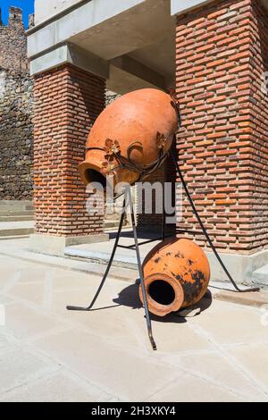 Old traditional georgian wine region symbol background with qvevri jug Stock Photo