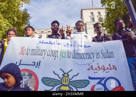 London, UK. 30th Oct, 2021. Protesters hold an anti-coup banner during the demonstration. Large crowds gathered outside Downing Street in protest against the military coup in Sudan and demanded a return to civilian rule. Credit: SOPA Images Limited/Alamy Live News Stock Photo