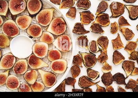 Sliced fresh and dried figs lie on the table. Top view Stock Photo