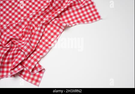 Folded cotton red white checkered napkin on a white background Stock Photo