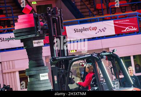 Aschaffenburg, Germany. 30th Oct, 2021. German championships in forklift driving, StaplerCup 2021, were held. The final of the forklift truck driving championships was organised by Linde Material Handling GmbH: Barbara Marr, German Vice Champion in forklift truck driving 2021, stacks up several segments to form a tower. Credit: Andreas Arnold/dpa/Alamy Live News Stock Photo