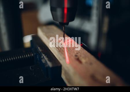 Drilling machine with laser sight in the workshop. Stock Photo