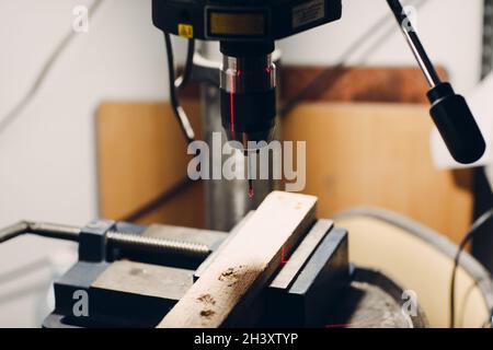 Drilling machine with laser sight in the workshop. Stock Photo