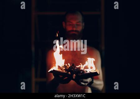 Man hold burning book in his hands. Stock Photo