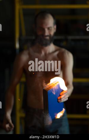 Man hold burning book in his hands. Stock Photo