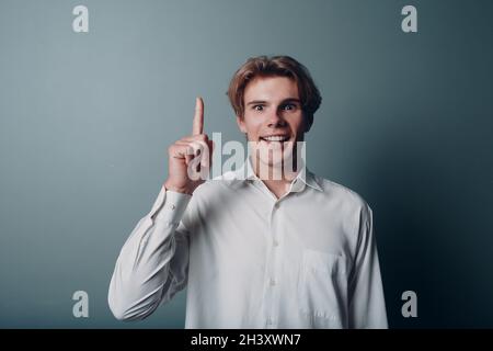 Young man pointing and forefinger index finger up. Stock Photo