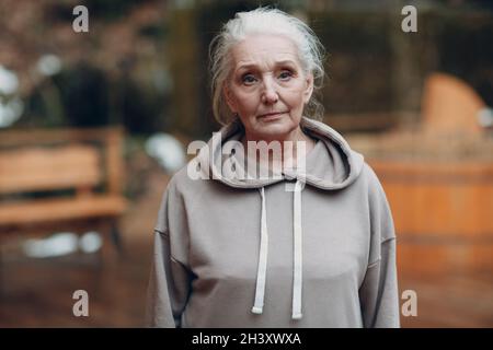 Portrait of mature gray haired elderly woman outdoor. Stock Photo