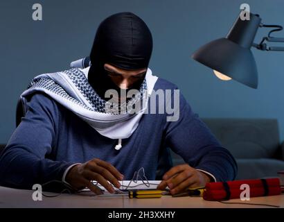 Terrorist bomber preparing dynamite bomb Stock Photo