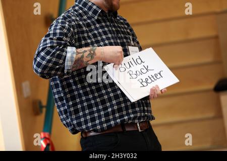 A man holding a sign for 'Build Back Better' a slogan made up by PM Boris Johnson and the Conservative Party after Brexit and Coronavirus. Stock Photo