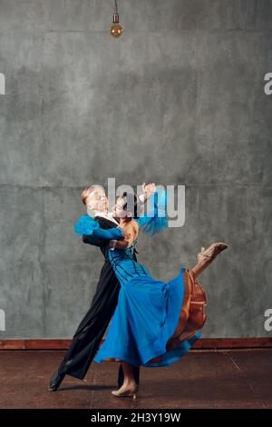 Foxtrot Ballroom dance. Young couple dancing in studio. Stock Photo