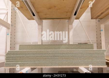 OSB wooden chipboard sheets stacked in store. Stock Photo