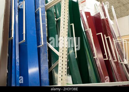 Siding metal multi-colored pallet row set rack ready for construction on hardware industrial store Stock Photo