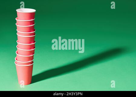 Stack of red paper cup on green background Stock Photo