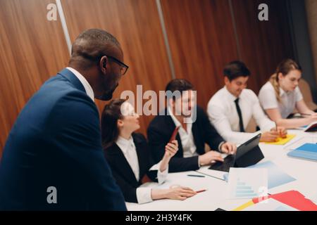 Businessman and businesswoman team at office meeting. Business people group conference discussion sit at table with boss man and Stock Photo