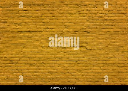 yellow seamless texture and full frame background of brick wall covered with matte plaster Stock Photo