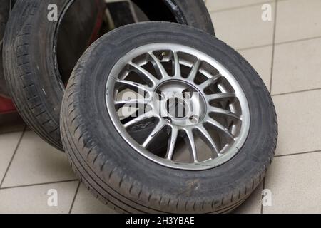 Mechanic changing car tire fitting. Wheel with tyre close up. Stock Photo