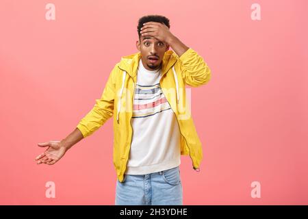 Dude where is my car. Portrait of shocked frustrated and confused handsome stylish young african american male student in yellow Stock Photo