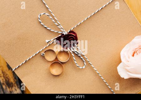 Gold rings on craft packaging with a red wax seal. Stock Photo