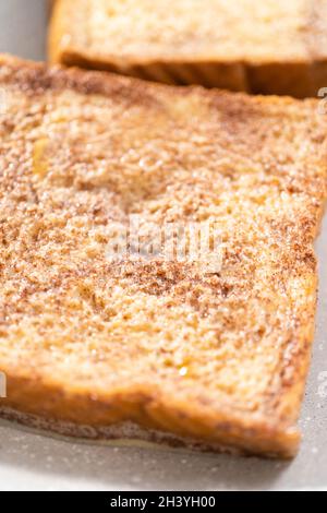 Frying french toast in a nonstick frying pan. Stock Photo