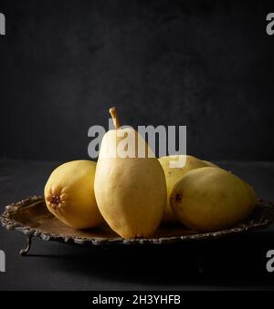 Ripe green pears on a metal plate, black background Stock Photo