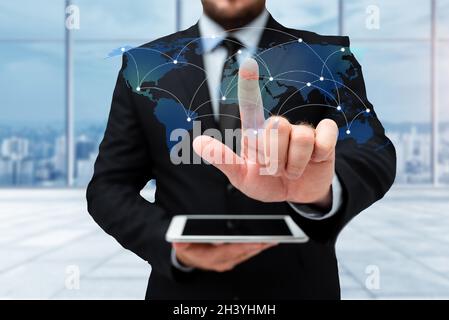 Man In Uniform Standing Holding Tablet And Virtually Typing With Pen. Business Man Carrying Pad Typing And Displaying New Futuri Stock Photo
