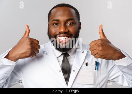 Healthcare, medicine and hospital treatment concept. Close-up portrait of satisfied, happy african-american doctor, physician as Stock Photo