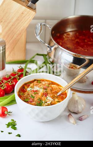 Ukrainian and Russian traditional red beet soup borsch, made from beets, cabbage, potatoes, beef and tomatoes Stock Photo