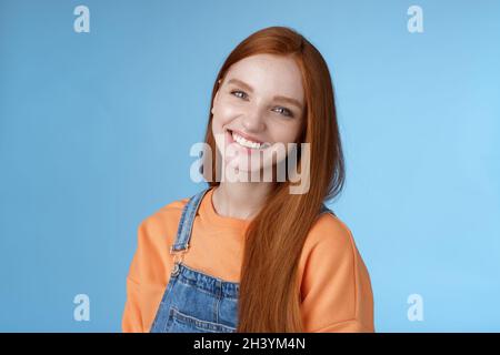 Pleasant sincere happy ginger girl blue eyes tilting head grinning happily laughing stay positive lucky spend time best friends Stock Photo