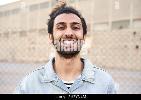 Cute brunette man laughing in the street. Stock Photo