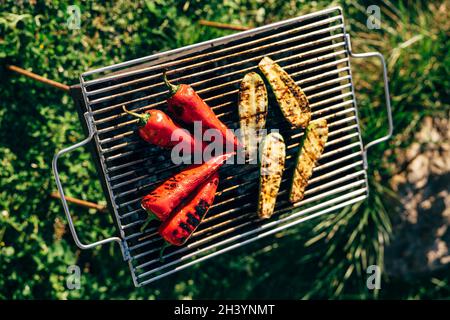 Grilled vegetables on the grill outside. Sliced zucchini and paprika. Stock Photo