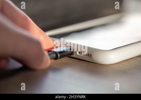 Magnetic cable for charging smartphone, close up. Stock Photo