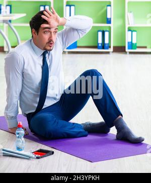 Employee doing exercises during break at work Stock Photo