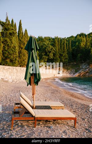 Close-up of wooden loungers on a sandy beach. The royal beach near Villa Milocer, montenegro. Stock Photo