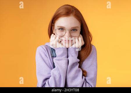 Lovely cute redhead sweet silly girl geek university student wearing glasses lean hand smiling tenderly look affection adore lis Stock Photo